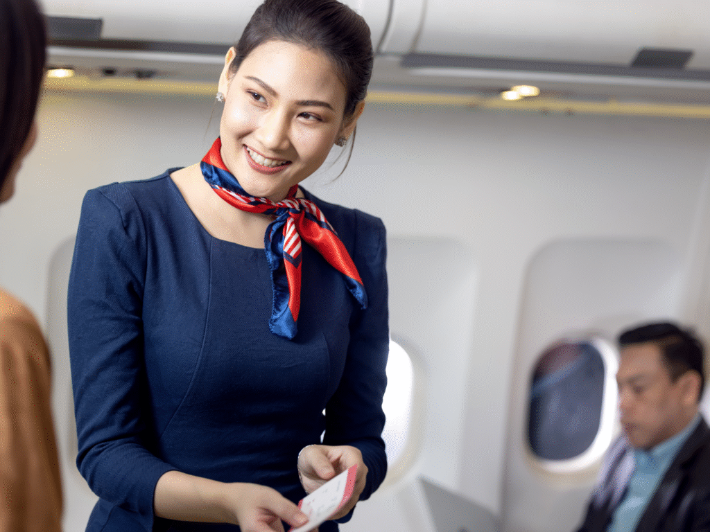 Cabin crew member greeting a passenger on board